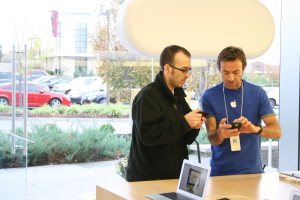 An Apple staff member helps a customer