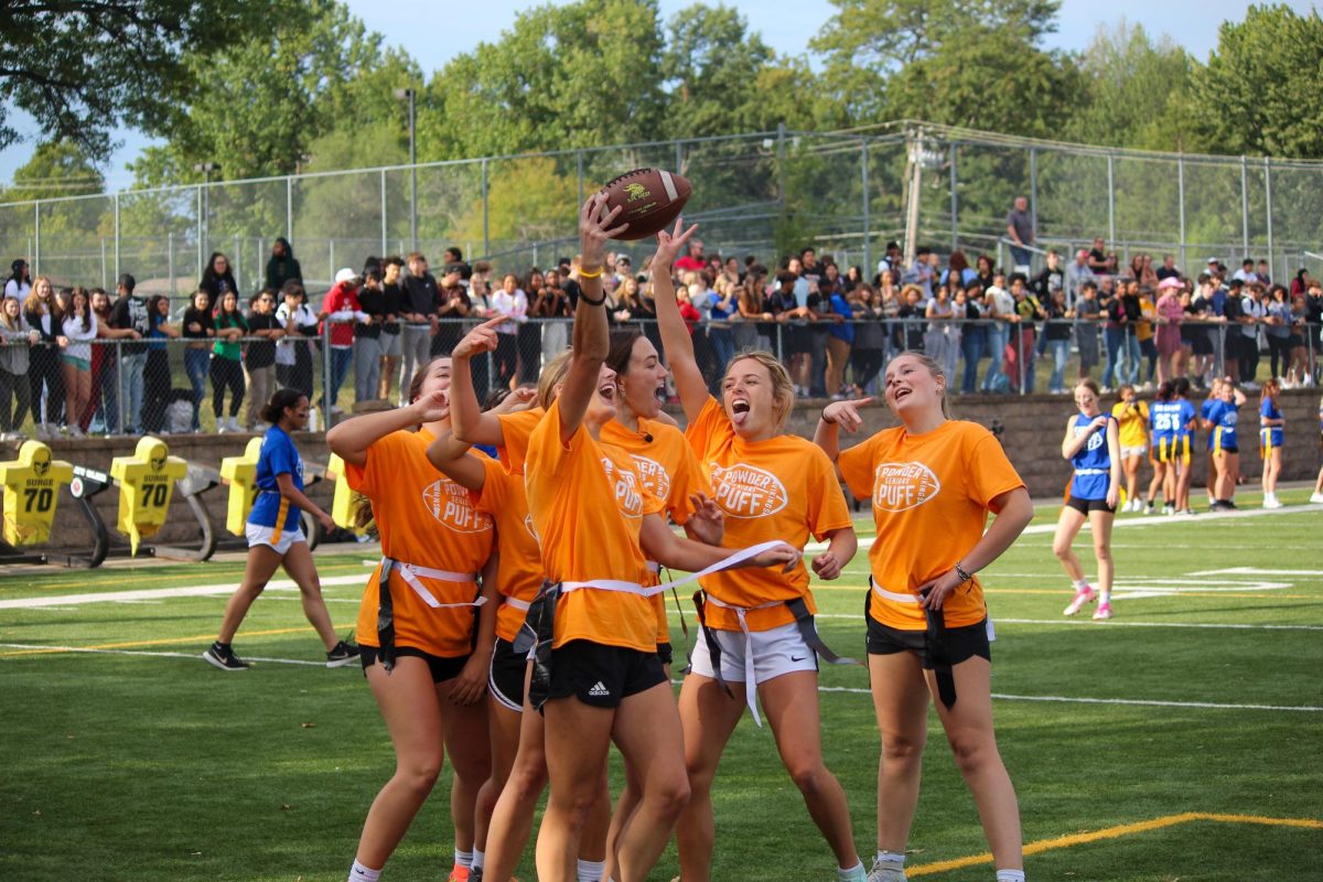 The senior girls powder puff team taking a selfie with their football after scoring a touchdown for the seniors!