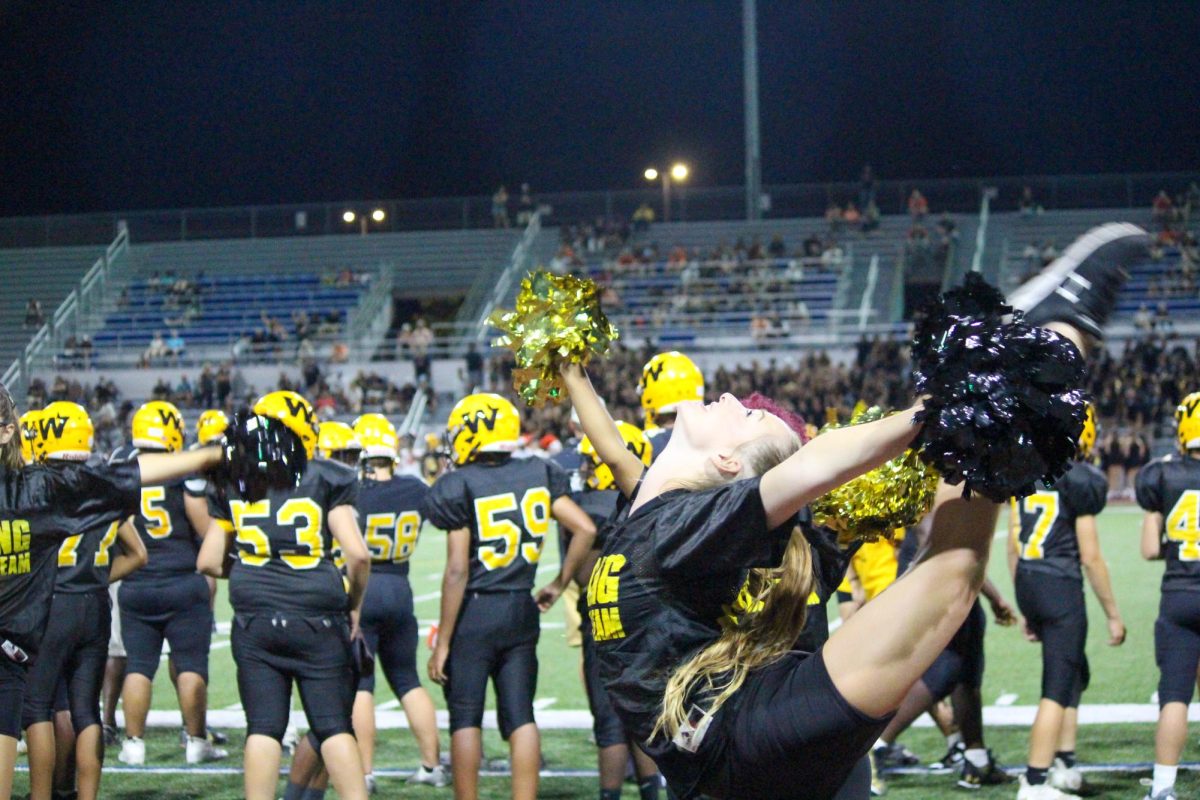 Caitlin Besse dancing for the crowd during the varsity football game. 